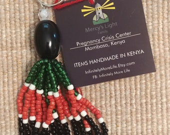 KENYA FLAG TASSEL Key Chain/purse charm. Large Black Focal Bead with green/red/black beaded tassel. Beads of Hope.  Made in Kenya.