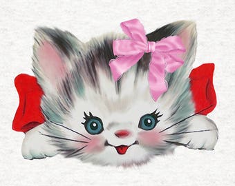 May include: A white kitten with gray stripes peeks over a red bow. The kitten has blue eyes and a pink bow with white lace on top of its head.