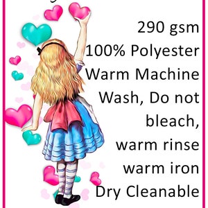May include: A white care label with a cartoon illustration of a girl in a blue dress and pink hearts. The label includes the text "POLYESTER CARE", "290 gsm", "100% Polyester", "Warm Machine Wash, Do not bleach, warm rinse, warm iron", "Dry Cleanable", and care symbols including a 40C symbol, a triangle with an X, an iron with a dot, a circle with a P, and a circle with an X.