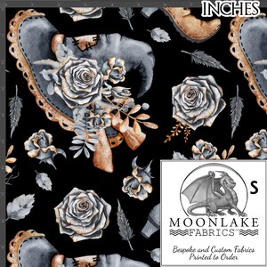 May include: A black fabric with a repeating pattern of silver witch's boots, silver roses, and gold leaves. The fabric is printed with the text "MOONLAKE FABRICS" and "Bespoke and Custom Fabrics Printed to Order".