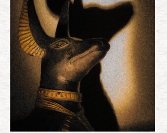 May include: A golden Anubis statue with a black body and gold accents. The statue is set against a light brown background with a shadow of the statue behind it.