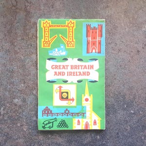 May include: A retro travel guide for Great Britain and Ireland, with a green cover. The cover displays illustrations of iconic landmarks such as a bridge, castle, and church, with red, yellow, and blue accents. The title is prominently displayed.