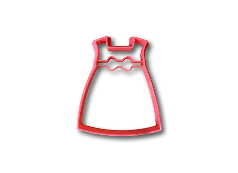 May include: A pink plastic cookie cutter shaped like a dress with a bow at the waist.