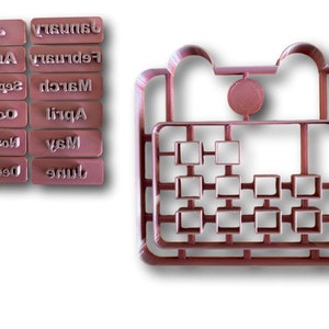 Könnte beinhalten: Ein Satz von 12 braunen Stempeln aus Kunststoff mit den Monaten des Jahres darauf gedruckt. Die Stempel sind in zwei Reihen zu sechs angeordnet. Es gibt auch einen braunen Stempel aus Kunststoff mit einem Kreis für das Jahr und einem Raster für die Tage des Monats.