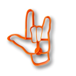 May include: Orange plastic cookie cutter shaped like a hand making the sign for "I love you" in American Sign Language.