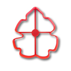 May include: A bright red, flower-shaped cookie cutter. The cutter has a rounded, petal-like design with a central circle and cross-shaped supports. The cutter is made of plastic and is designed for baking.