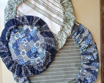 May include: Three round fabric bowl covers with elasticized edges. One cover features a green floral print on a white background with white and green stripes. Two covers feature a blue patchwork pattern with white and blue stripes.