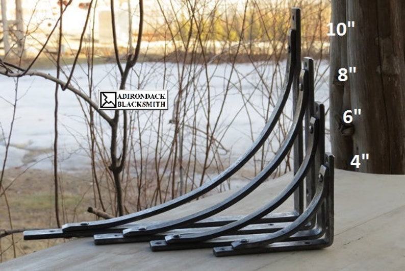 Size selection of our shelf brackets displayed in a true Adirondack setting with a rustic pine post in background. Sizes 4", 6", 8" and 10".