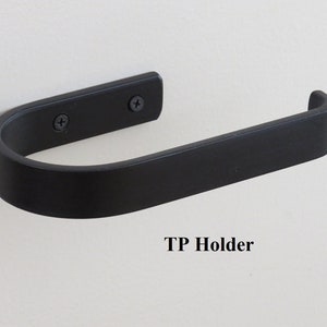 Same toilet paper holder with TP loaded. All steel, 1-piece construction with 3/4" bent tip on open end to retain tp. 2 matching screws and drywall anchors to fasten to the wall (included).