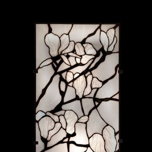May include: A stained glass panel with a design of white magnolia blossoms and black branches.