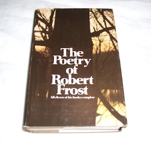 May include: A hardcover book titled "The Poetry of Robert Frost" with white text on a dark brown background. The cover features a tree silhouette design. The book includes all eleven of Frost's books.