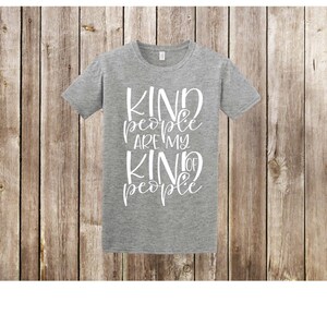 May include: Gray t-shirt with the text "Kind people are my kind of people" in white lettering.