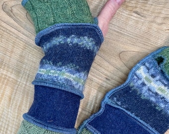 Arm wrist warmers made from preloved wool sweaters in blues and greens.