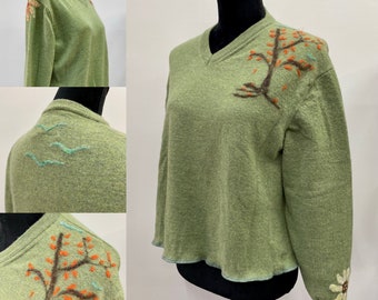 Upcycled mended merino wool v-neck sweater in lovely grass green. Needle felted moth holes with natural wool roving. Size L.