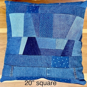 Recycled jeans patchwork pillow. 20” square with pockets for remotes or phone. Pillow cover only.