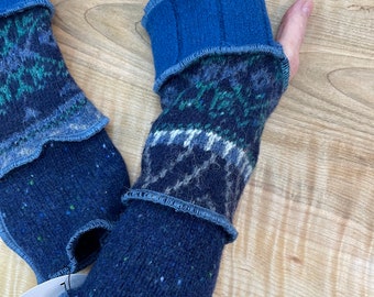 Arm wrist warmers made from preloved wool sweaters in blues and greens.