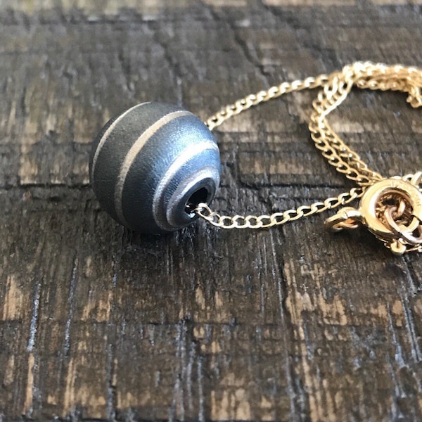 Ruthenium Gold charm necklace. Spiral bead necklace.