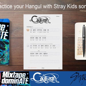 May include: A wooden surface displays a notebook, pen, and printed Hangul lyrics sheet. The sheet features the word "Cinema" and Korean text. A blue and teal "Mixtape: Dominate" notebook is on the left.