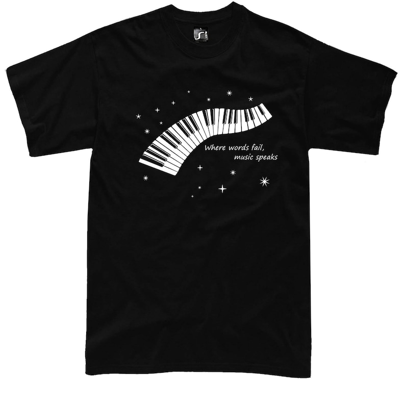 Black t-shirt with a white graphic of a piano keyboard in the shape of a crescent moon. The text "Where words fail, music speaks" is printed below the keyboard.