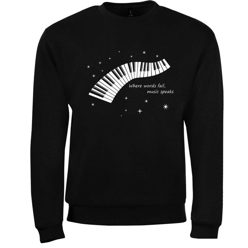 Black sweatshirt with a white graphic of a piano keyboard and the text "Where words fail, music speaks."