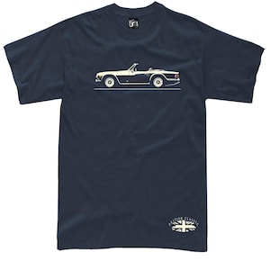 May include: Navy blue t-shirt featuring a white and black illustration of a classic convertible car. The car is depicted in profile, with details like the wheels and convertible top visible. The text "British Classics" and a Union Jack flag are at the bottom.