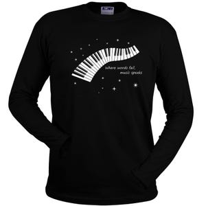 Black long-sleeve t-shirt with a white piano keyboard design and the text "Where words fail, music speaks".