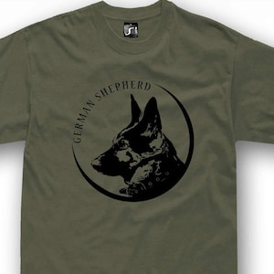 A t-shirt with a graphic design featuring a black silhouette of a German shepherd dog's head within a circular frame.
