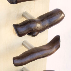 May include: Four wooden door handles with a dark brown stain finish. Each handle is attached to a silver metal base.