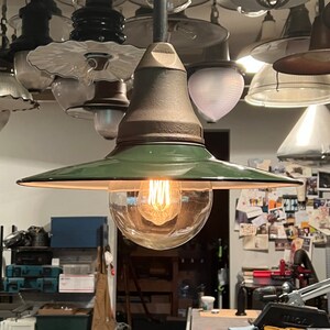 May include: A green and brown vintage industrial pendant light with a clear glass globe shade and a single light bulb.