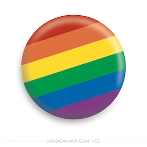 May include: A round button with the colors of the rainbow flag. The colors are red, orange, yellow, green, blue, and purple.