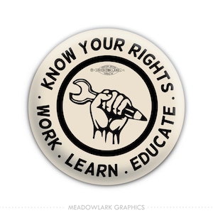 May include: A black and white button with the text "KNOW YOUR RIGHTS WORK. LEARN. EDUCATE." in a circle around a raised fist holding a wrench and pencil. The text "UNION CWA LABEL 1" is in a smaller circle at the top.