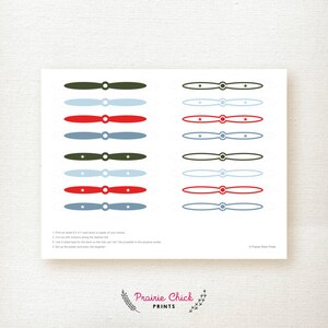 May include: A sheet of printable airplane propeller cutouts in shades of red, blue, and green, with star details. Includes instructions for printing and assembly. The Prairie Chick Prints logo is at the bottom.