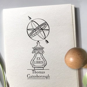 Spherical sundial Ex libris personalized Wooden stamp. The stamp design is a retro-style hand-drawn illustration. It shows the Spherical Sundial Garden Statue. The composition is vertical. Personalization text is typed below the image