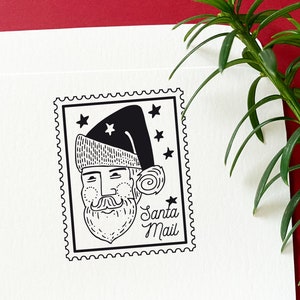 Tampon en caoutchouc pour Noël postal avec le Père Noël et la poste, parfait pour les cartes de Noël, les lettres et les étiquettes de cadeaux.