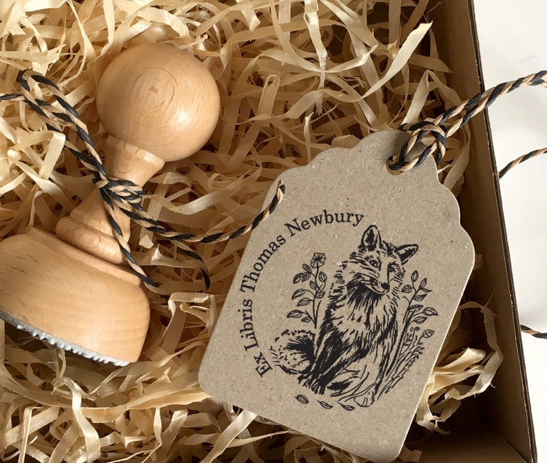 FOX Personalised Ex Libris Wooden Stamp. The illustration depicts a sitting fox in the greens. The style of the drawing is traditional, and vintage. The hand-drawn illustration recalls the one from the old books. The fox looks nice and friendly.