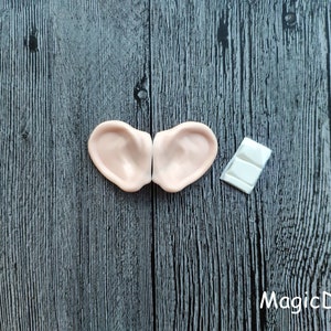 May include: Two flesh-colored, silicone elf ears with a white adhesive strip for attaching them to the head.