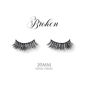 May include: A pair of black false eyelashes made with mink fibers. The text "Broken" is written in a cursive font above the eyelashes. The text "20MM MINK FIBERS" is written below the eyelashes.