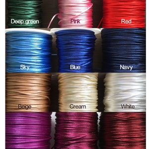 May include: Twelve spools of waxed cotton cord in various colors, including deep green, pink, red, sky blue, blue, navy, beige, cream, white, purple, plum, and wine.