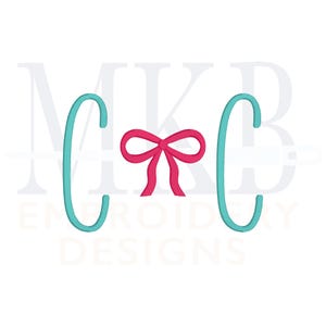 May include: Monogrammed embroidery design with the letters "C" and "C" on either side of a pink bow. The letters are turquoise blue.