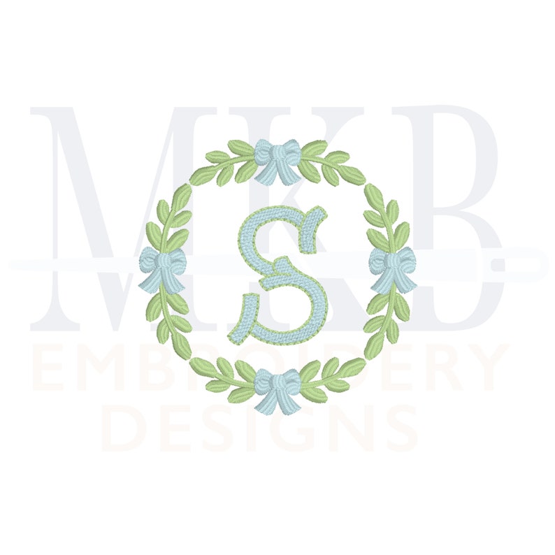 May include: A green wreath with blue bows and a light blue letter "S" in the centre. The wreath is surrounded by the text "MKB EMBROIDERY DESIGNS".