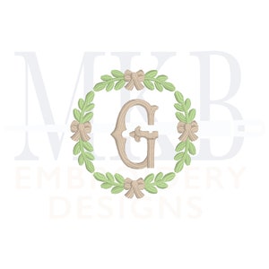 May include: A monogram design featuring the letter "G" in a brown font, surrounded by a wreath of green leaves and brown bows.