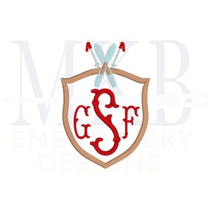 May include: A red monogram with the letters "GSF" inside a brown shield with a pair of crossed skis on top. The shield is surrounded by the text "MKB Embroidery Designs".