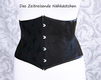 Zwarte Victoriaanse taillecorset gemaakt van bloemencoutil – handgemaakt, stabiel en elegant voor gotische, historische en regency-looks.