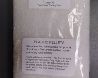May include: A clear plastic bag filled with white plastic pellets. The bag has a label that reads "Floatable Plastic Pellets 1 pound Twin Pines Trading Post". The label also includes instructions for using the pellets in a rock tumbler.