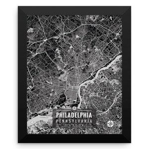 May include: Black and white framed map print of Philadelphia, Pennsylvania. The map shows the city's streets, waterways, and landmarks. The city name and coordinates are printed at the bottom. The frame is black.