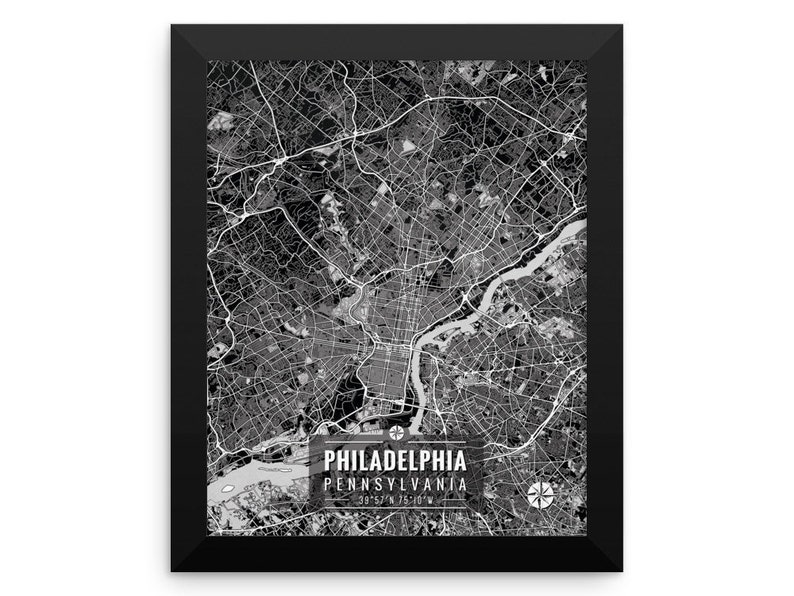 May include: Black and white framed map print of Philadelphia, Pennsylvania. The map shows the city's streets, waterways, and landmarks. The city name and coordinates are printed at the bottom. The frame is black.
