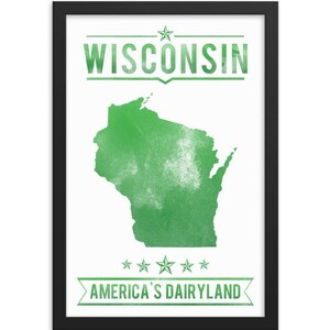 May include: A framed print featuring the state of Wisconsin in green against a white background. The word "WISCONSIN" is printed at the top, and "AMERICA'S DAIRYLAND" is at the bottom. The print is in a black frame.