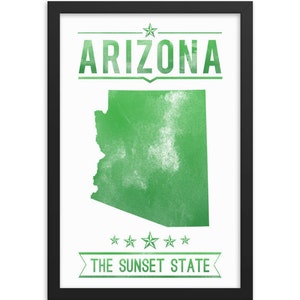 May include: Framed print featuring a green map of Arizona with the word "ARIZONA" above and "THE SUNSET STATE" below. The text and map are in a distressed style, set against a white background within a black frame.
