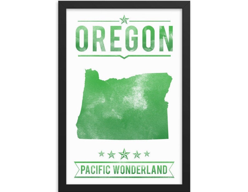 May include: A framed print featuring the state of Oregon in green, with the word "OREGON" above the state outline. Below the outline, the text reads "PACIFIC WONDERLAND". The print is in a black frame.