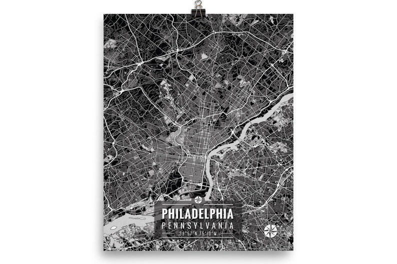 May include: Black and white map print of Philadelphia, Pennsylvania, with street and road details. The city map includes the text "PHILADELPHIA PENNSYLVANIA" and coordinates. The print is held by a silver clip.
